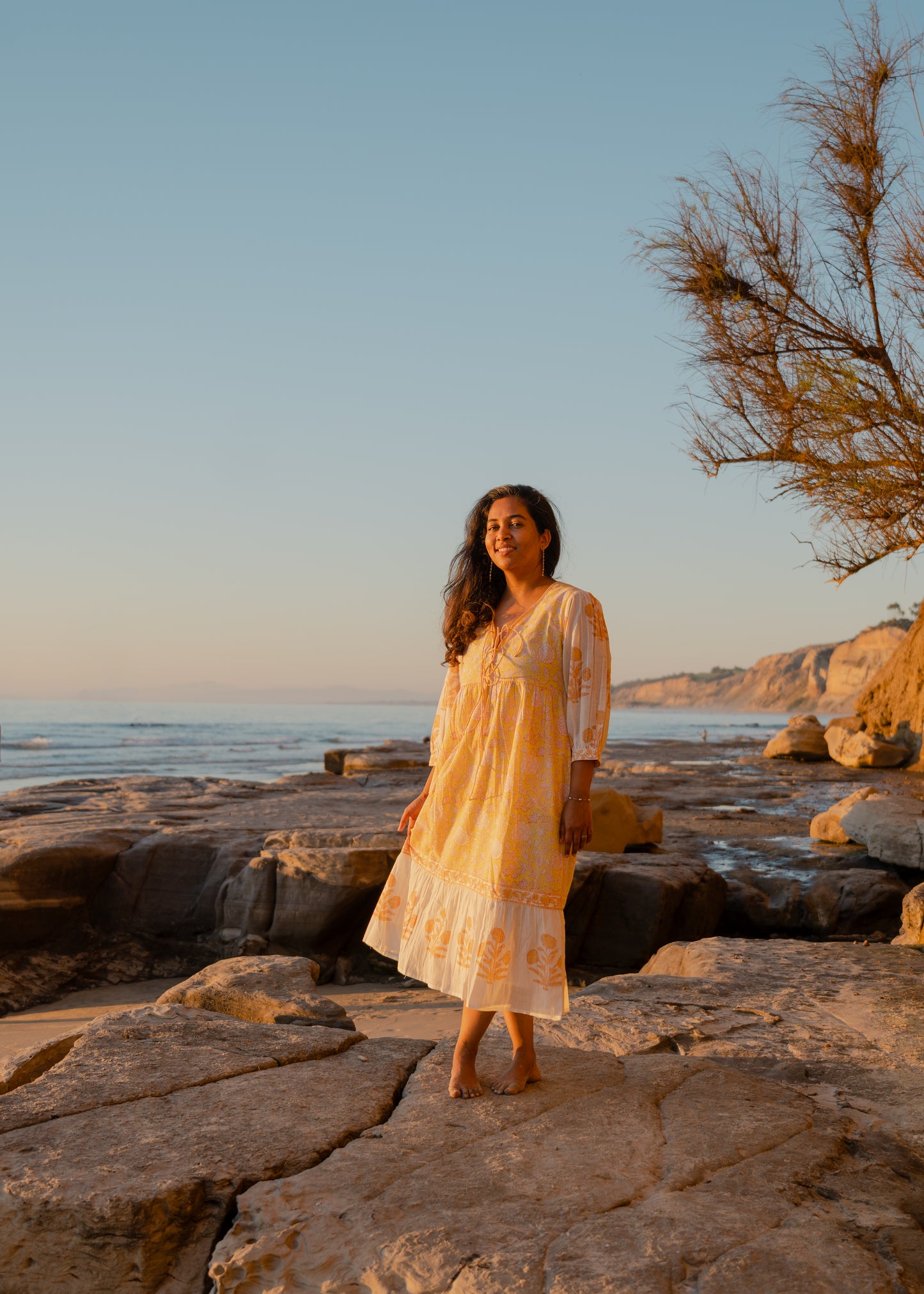 Yellow hand block printed cotton dress with sheer sleeves and floral pattern, sustainable boho vacation wear by Moksha Looms