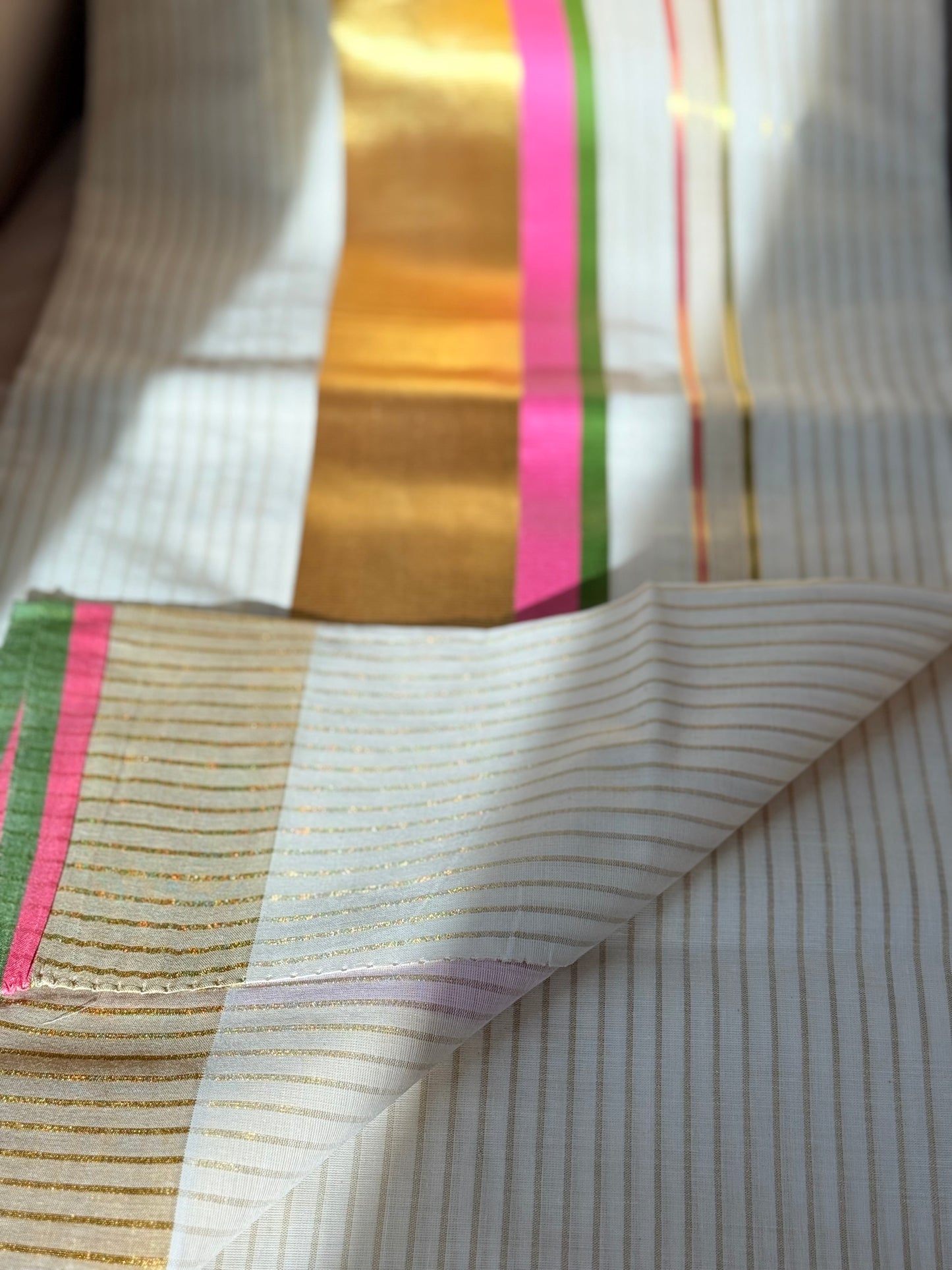 This traditional Kerala saree features a vibrant combination of pink and green hues, expertly woven in breathable cotton fabric. The intricate gold zari work adds a touch of opulence, reflecting the rich cultural craftsmanship of Kerala. Ideal for those who appreciate authentic heritage textiles with a sophisticated finish. Pink kerala saree in cotton

