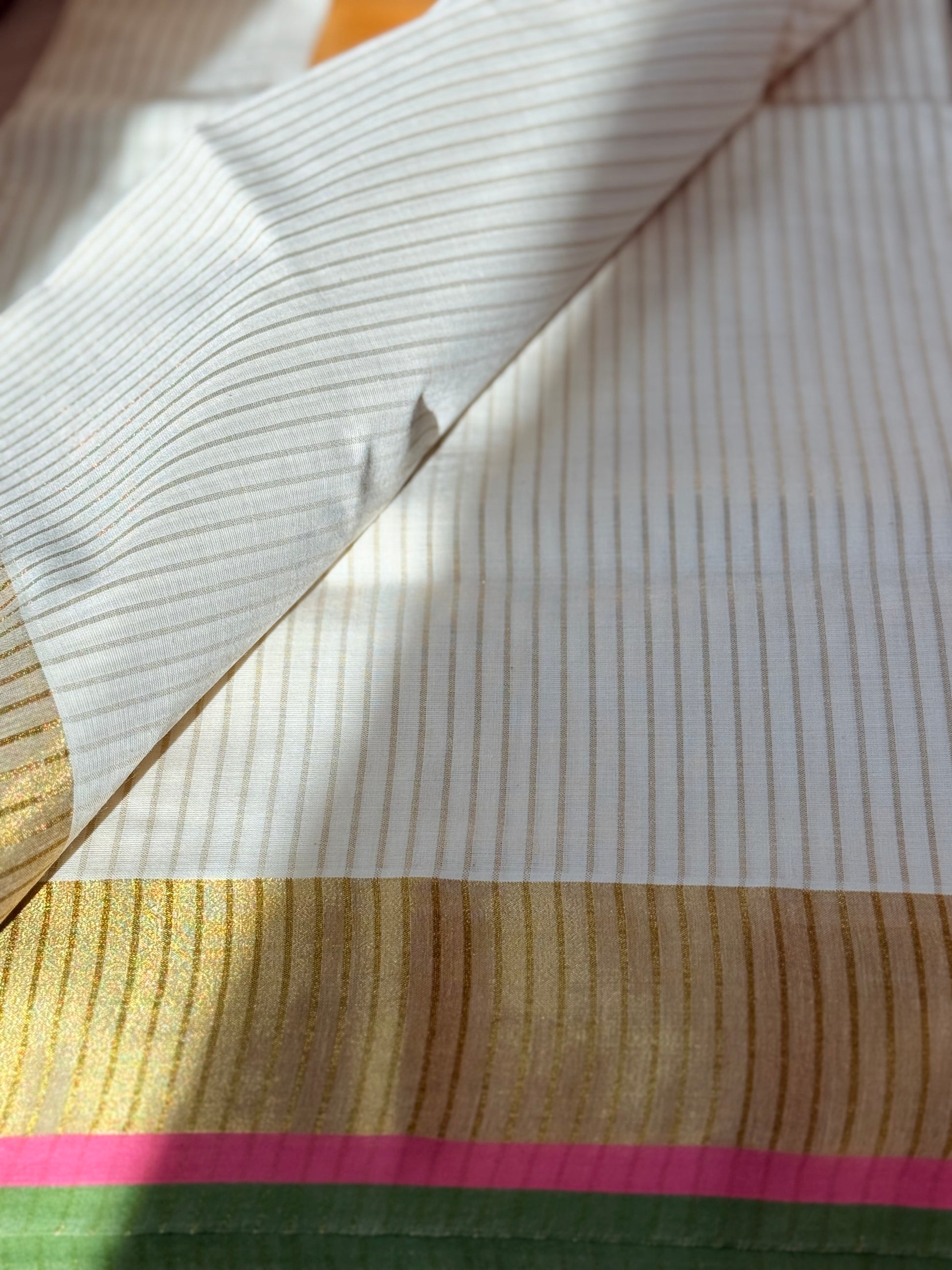 This traditional Kerala saree features a vibrant combination of pink and green hues, expertly woven in breathable cotton fabric. The intricate gold zari work adds a touch of opulence, reflecting the rich cultural craftsmanship of Kerala. Ideal for those who appreciate authentic heritage textiles with a sophisticated finish. Pink kerala saree in cotton

