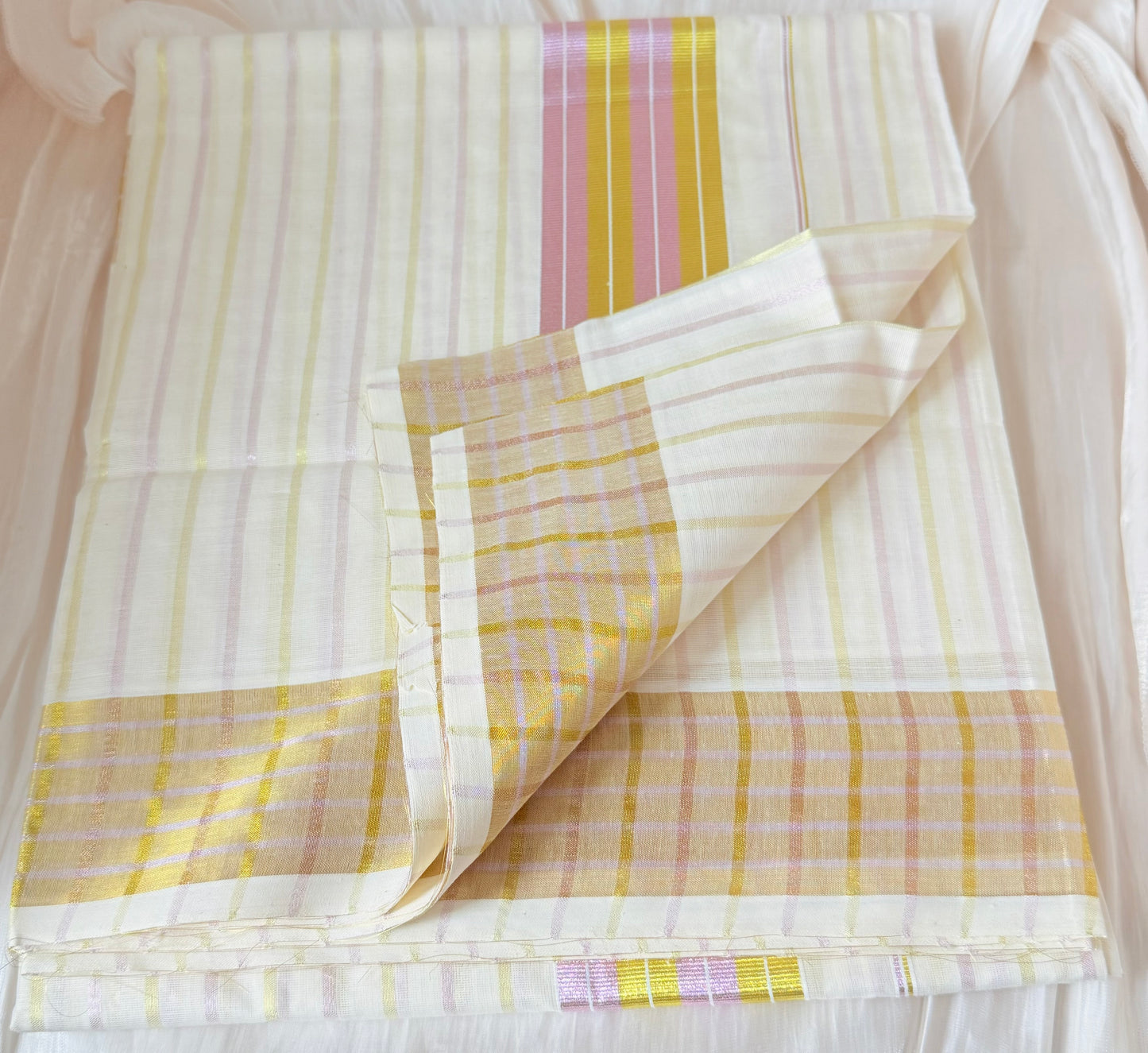 This Kerala saree features elegant pink and green stripes, blending traditional craftsmanship with vibrant colors. 