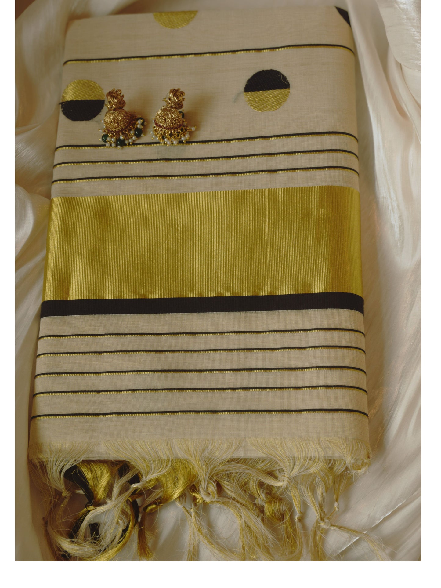 Striped fabric with gold earrings on a white background