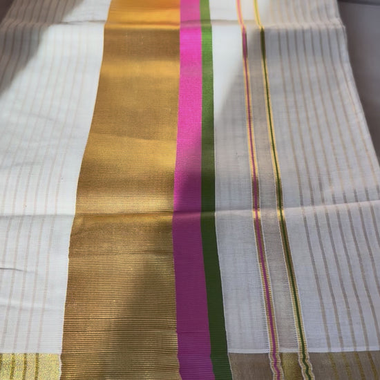 This traditional Kerala saree features a vibrant combination of pink and green hues, expertly woven in breathable cotton fabric. The intricate gold zari work adds a touch of opulence, reflecting the rich cultural craftsmanship of Kerala. Ideal for those who appreciate authentic heritage textiles with a sophisticated finish. Pink kerala saree in cotton

