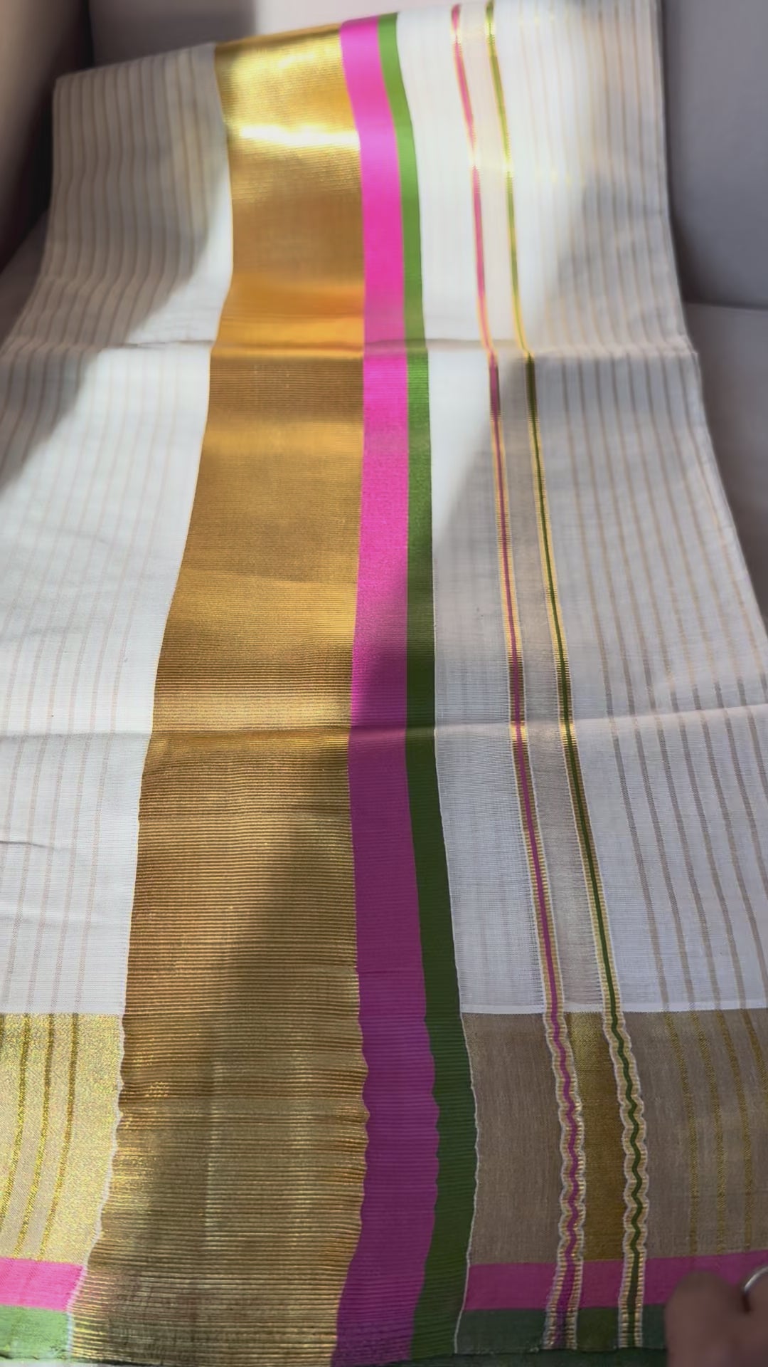 This traditional Kerala saree features a vibrant combination of pink and green hues, expertly woven in breathable cotton fabric. The intricate gold zari work adds a touch of opulence, reflecting the rich cultural craftsmanship of Kerala. Ideal for those who appreciate authentic heritage textiles with a sophisticated finish. Pink kerala saree in cotton


